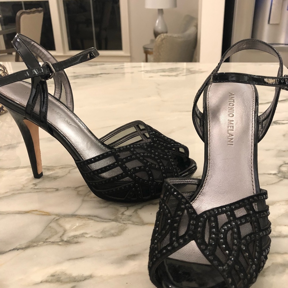 Black sling back peep toe pumps.